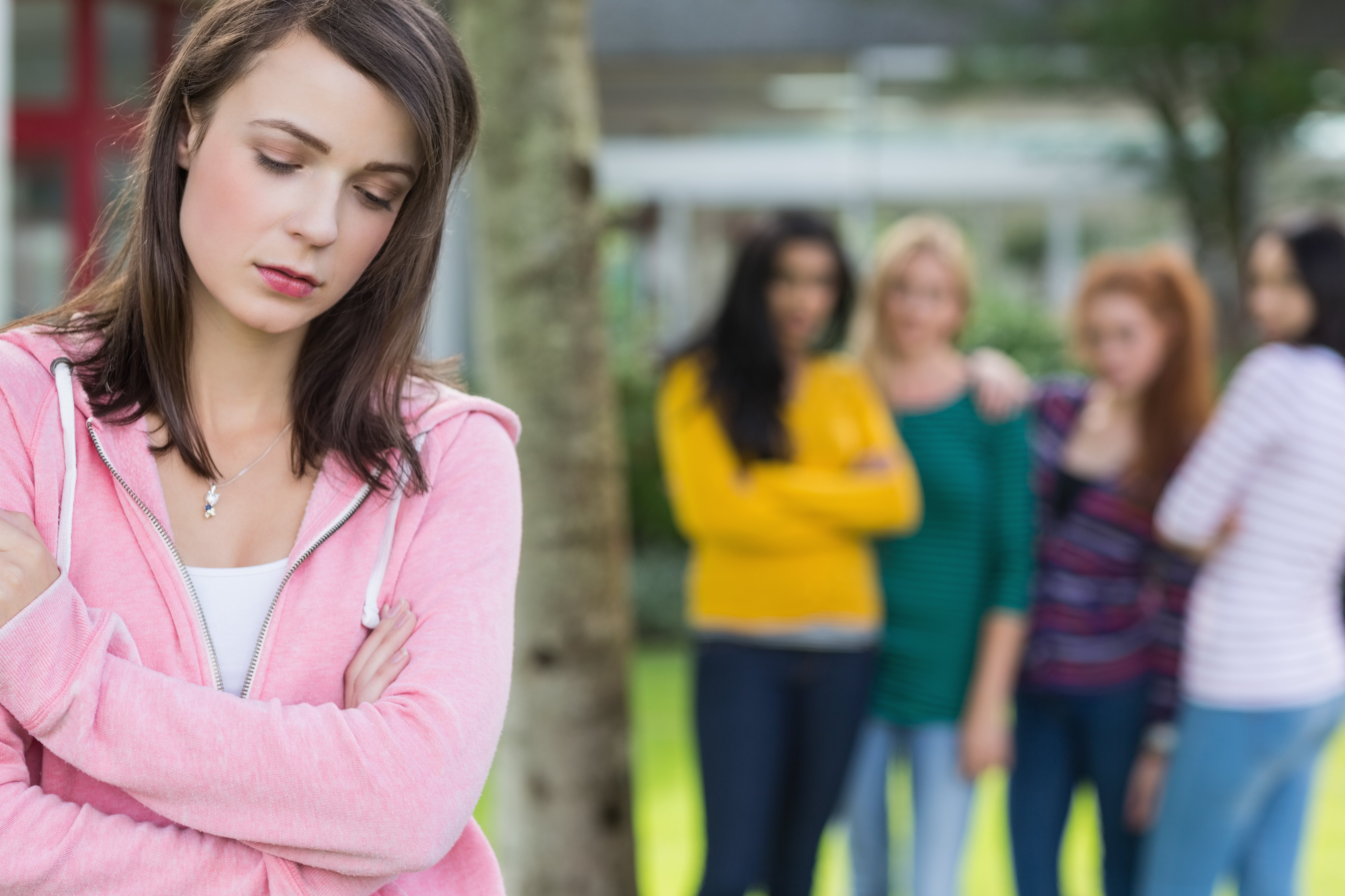 Young woman student appears bullied by other female students