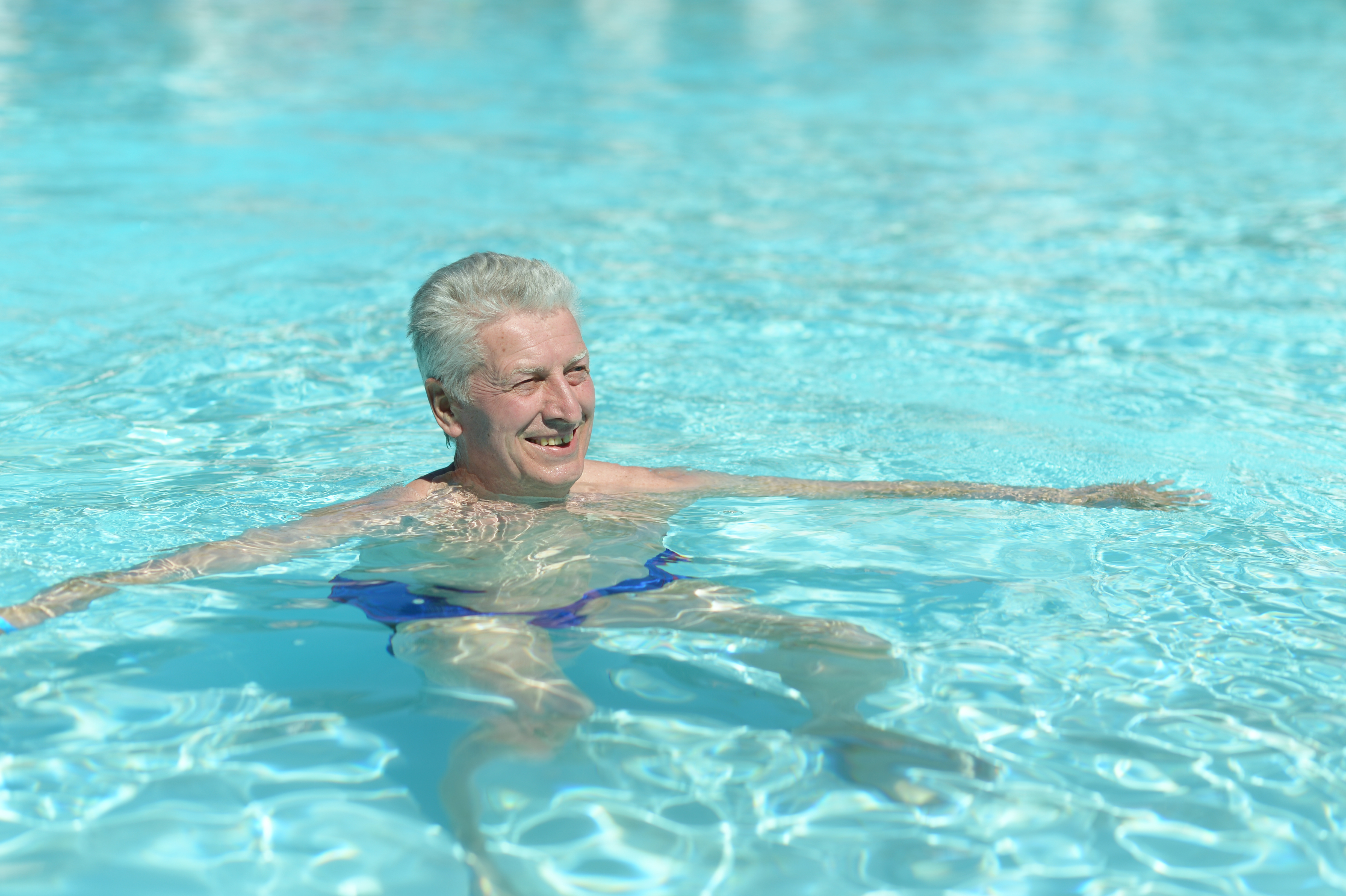 Senior man swimming in a pool