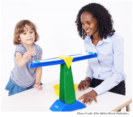 A young girl attempting the balance scale task