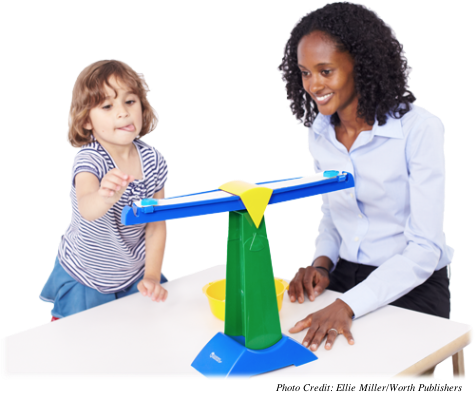 A young girl attempting the balance scale task