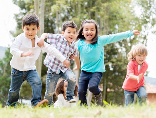 Group of small children playing in a park.
