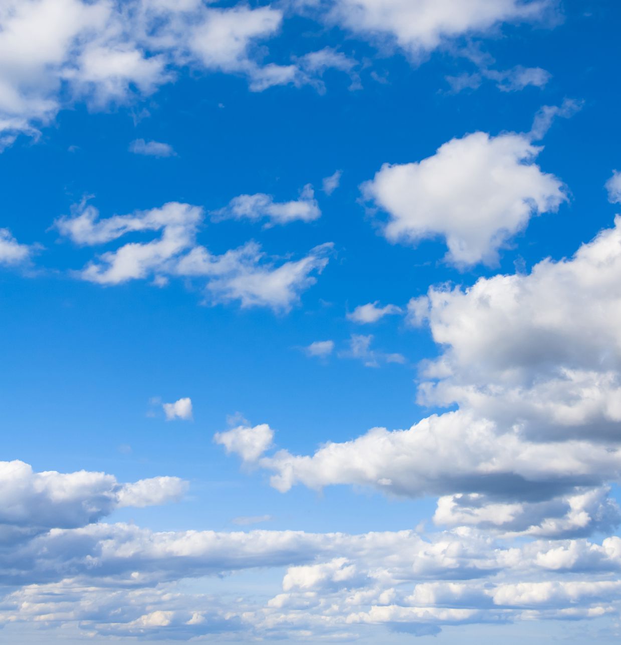 Color image of blue sky dotted with white clouds.