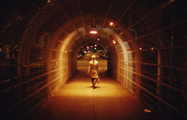 single individual walking on the dark street at night