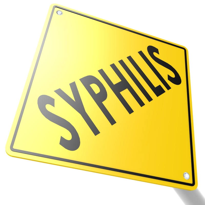 A yellow-colored sign with the word SYPHILIS written on it.