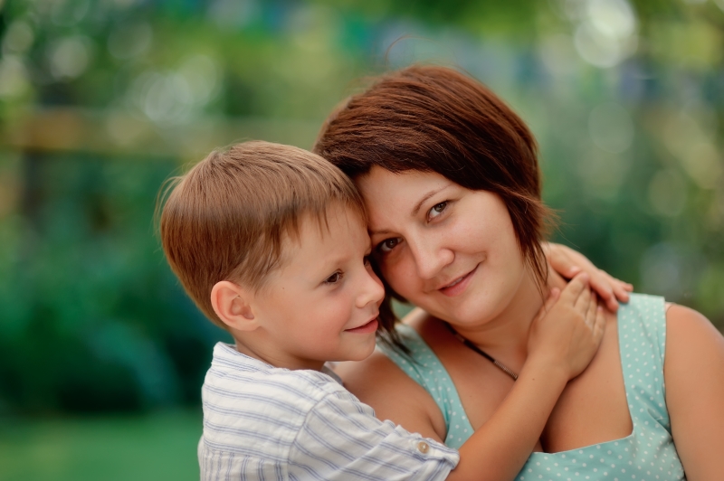 single mother never married: single mother with her young son hugging her