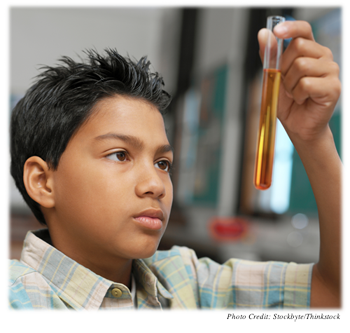 Boy studying a test tube