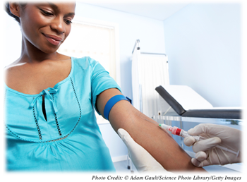 A pregnant woman getting blood drawn in a doctor’s office 