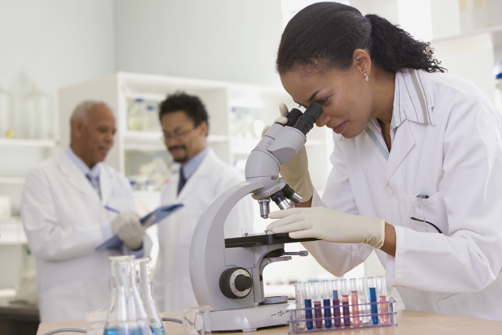 This photo shows a woman working in a scientific laboratory to signify the implicit biases against women who choose science as a field of study.