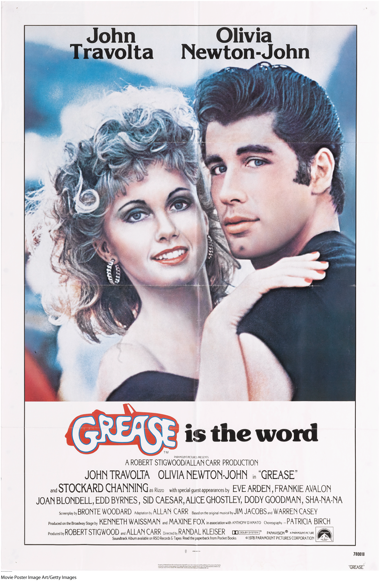 The film poster shows the two lead actors, John Travolta and Olivia Newton John, looking towards the camera and smiling.