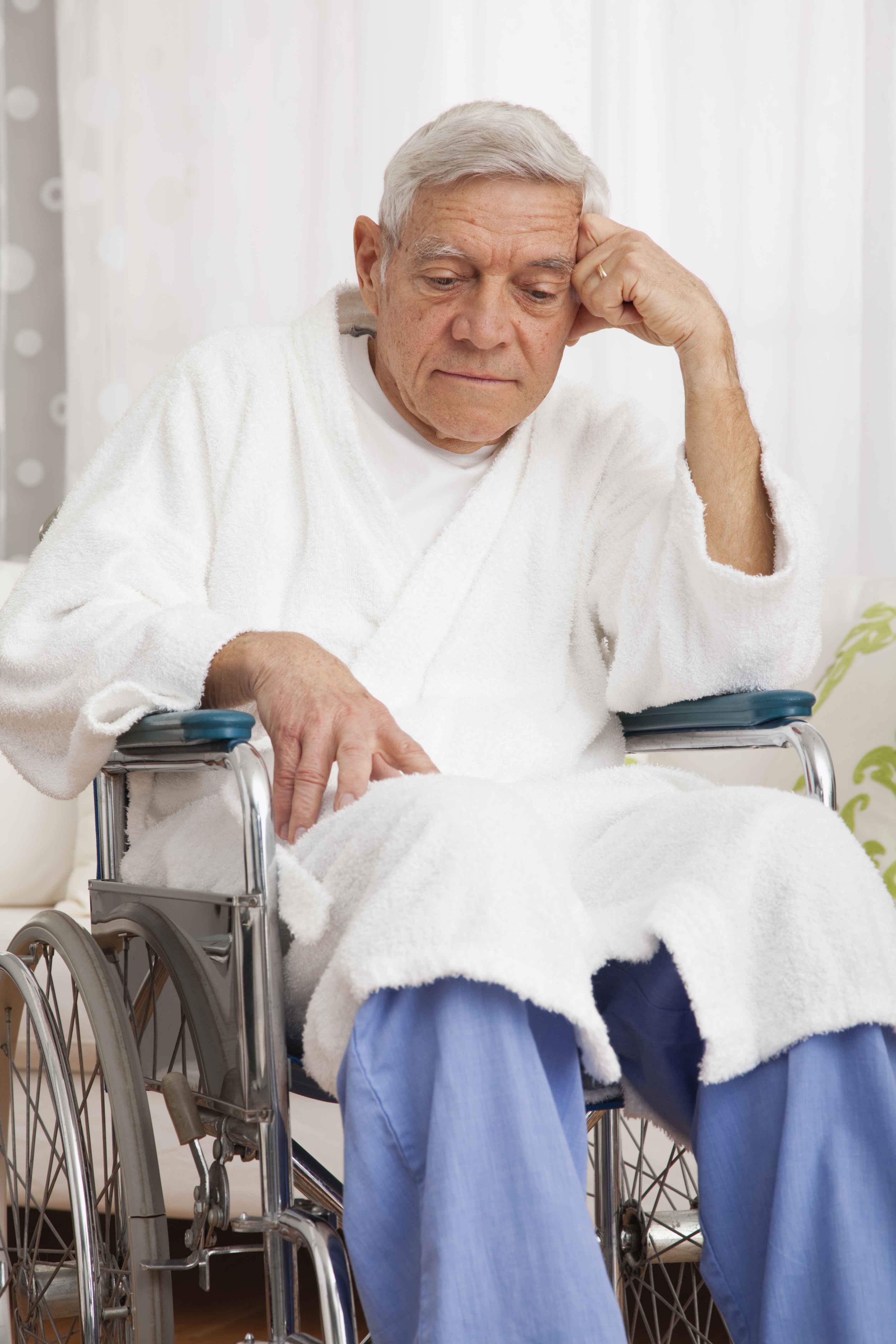 Sad senior man in a wheelchair.