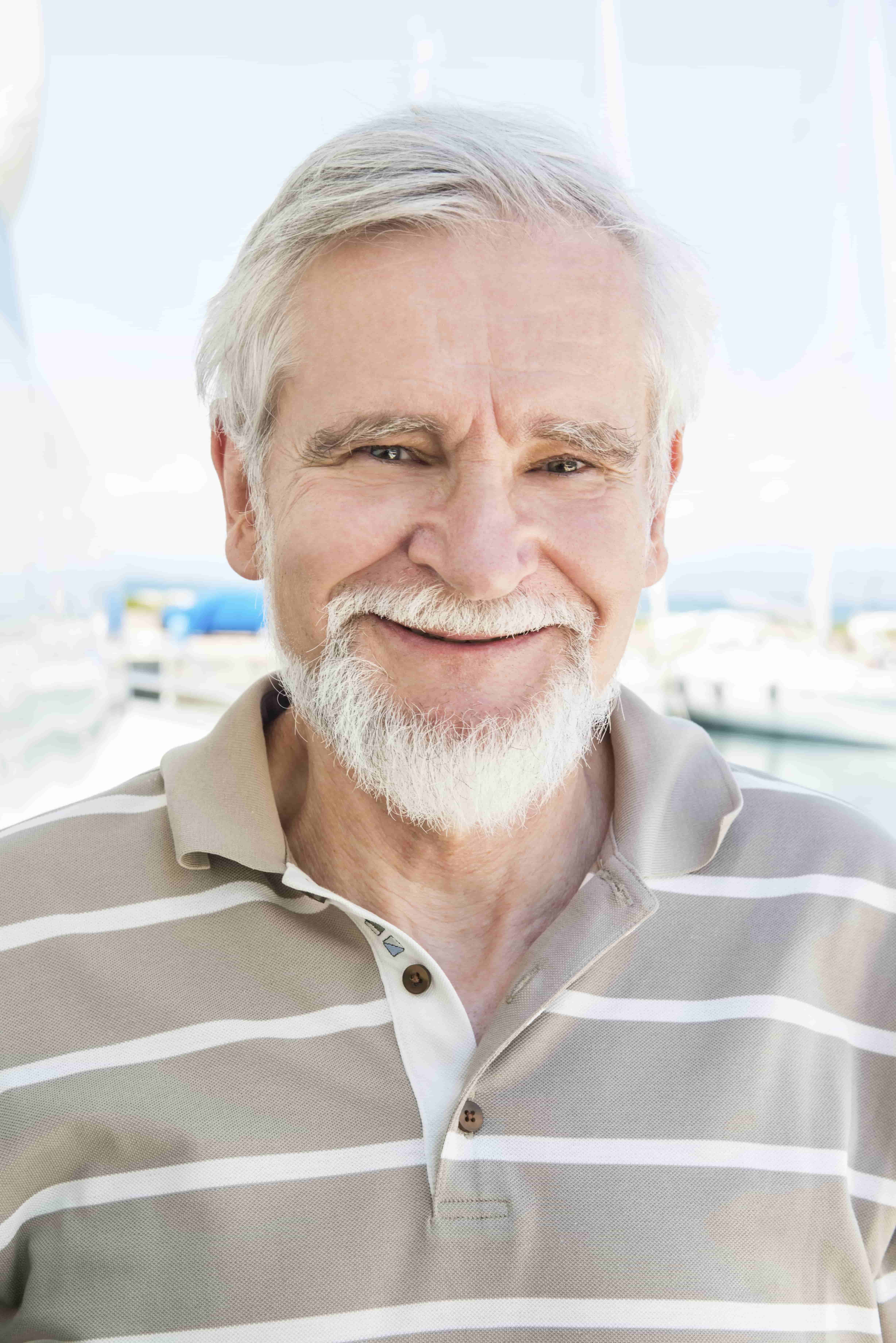 Close-up portrait of happy senior man outdoors