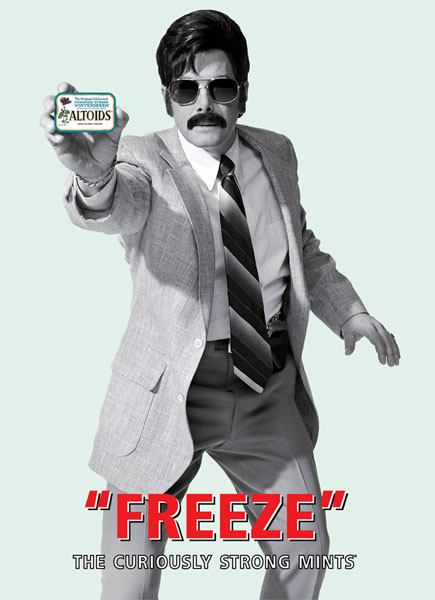 Advertisement for Altoids mints featuring a man dressed like a plainclothes police detective from a 1970’s TV show. He is flashing a tin of Altoids at the camera as a detective would show a badge. The text of the ad reads, “Freeze!”