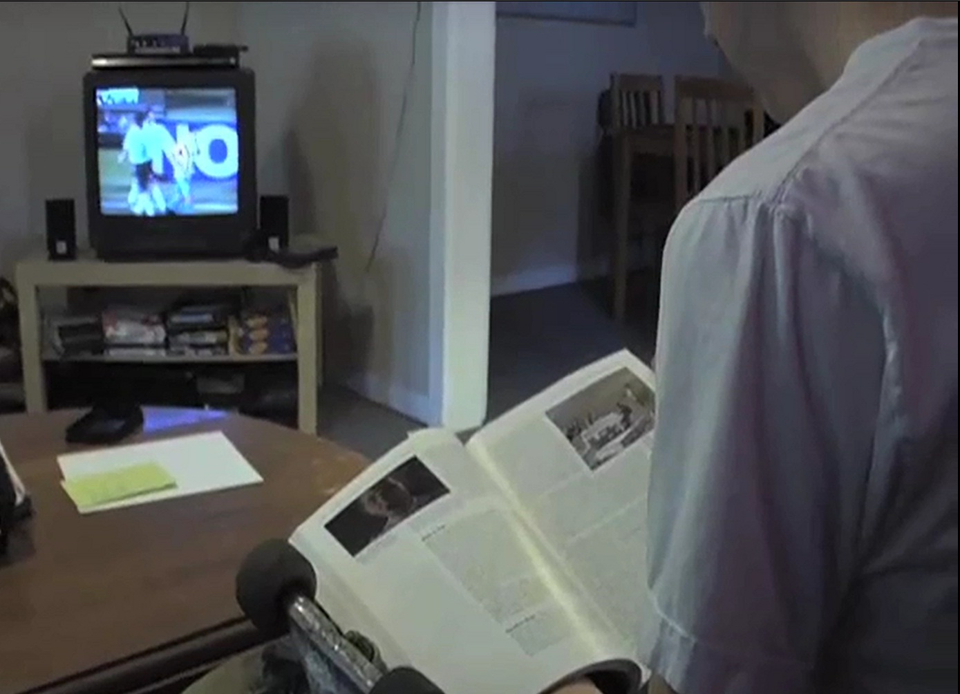 A student reading while watching television