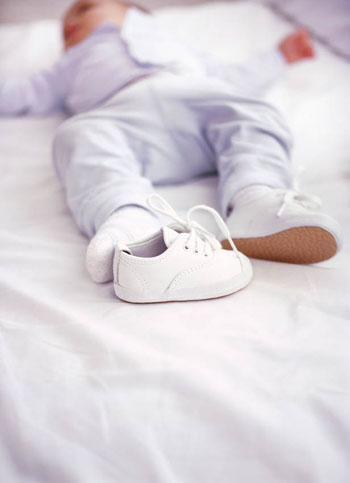 close-up of a baby's shoe come off a sleeping baby