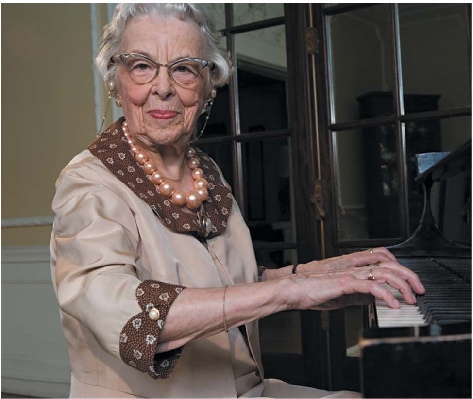An older woman playing the piano.