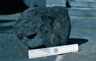 A presence of carbon and carbon compounds give meteorite its dark color.