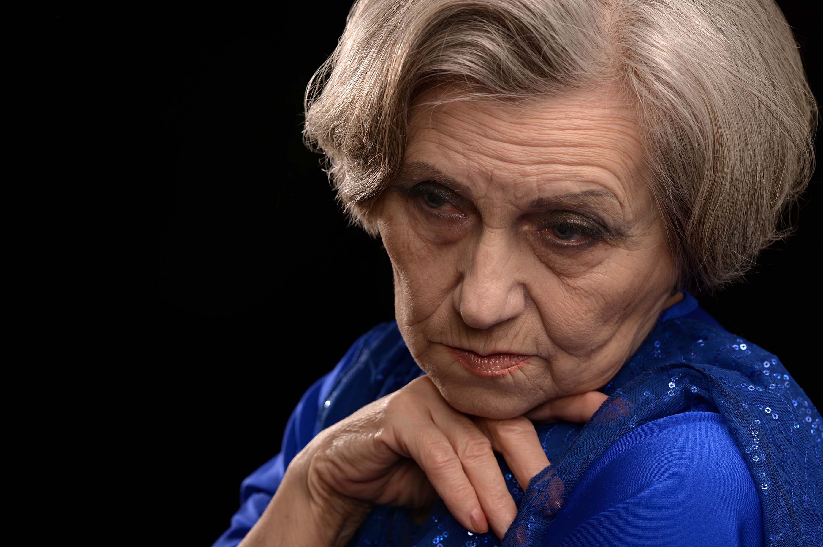 pensive-looking elderly woman
