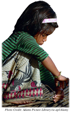 Young girl laborer weaving a mat in Cambodia