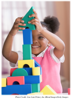 A young girl building with blocks