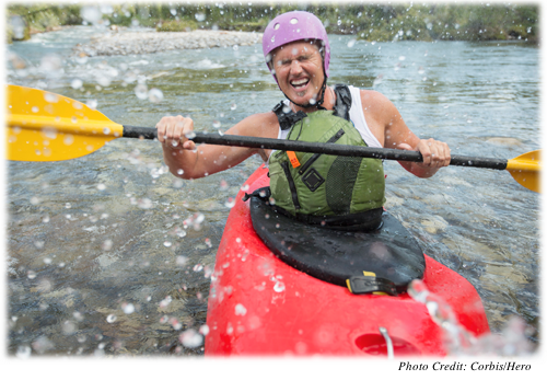 Older man laughing while kayaking