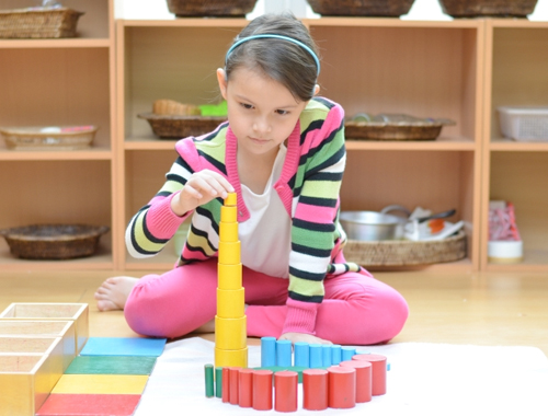 photo of young girl stacking blocks