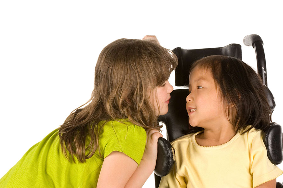Girl talking to her friend in wheelchair
