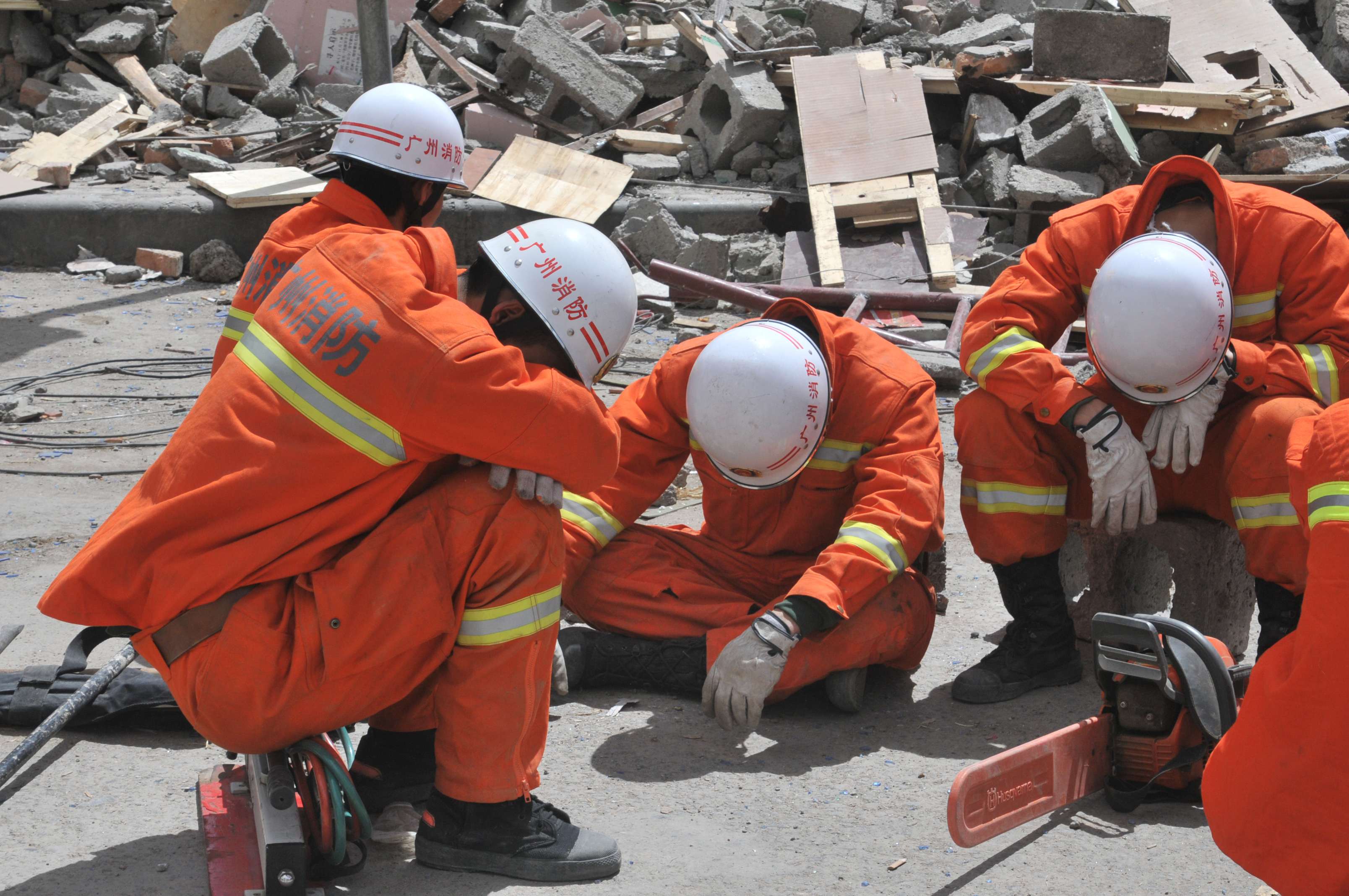 Photo of emergency worker obviously collapsed with fatigue during a disaster