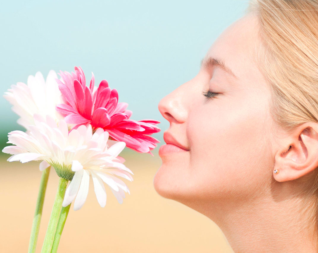 Photo: Close-up photo of a person smelling a flower
