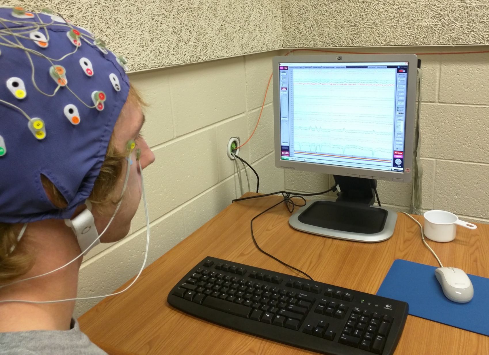 Show young male participating in an EEG experiment