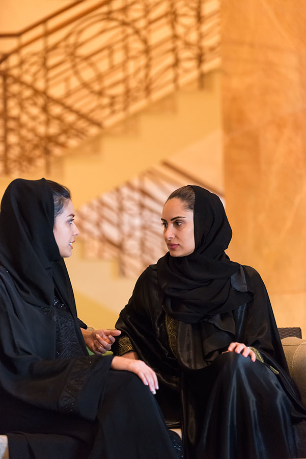Traditionally Dressed Middle Eastern Women Having Discussion in Hotel Lobby
