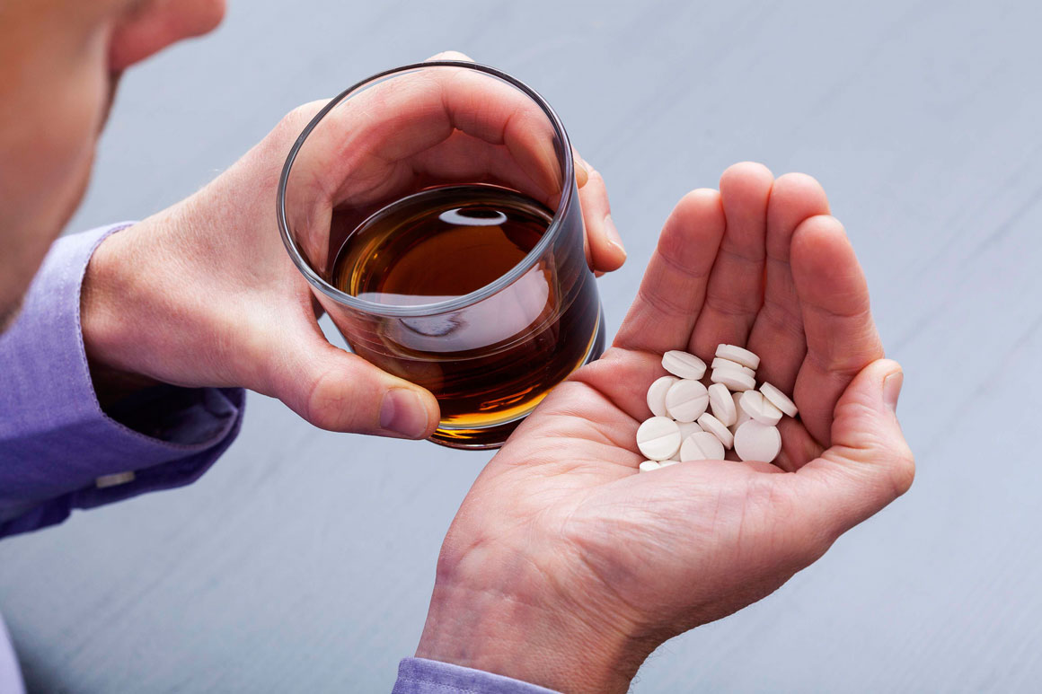 Photo: Alcoholic beverage AND prescription medications representing sleeping pills