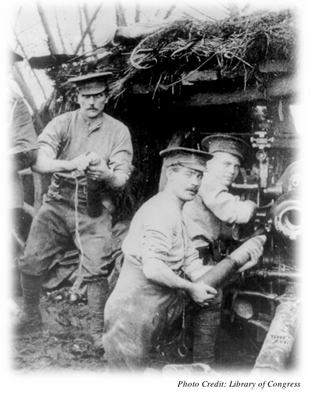 Three soldiers loading a canon in World War I 