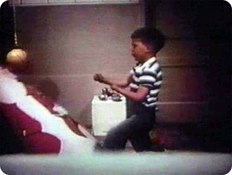 A young boy punching the doll with 1 or 2 fists