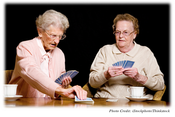 Two old women playing cards