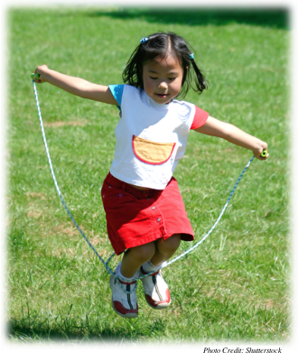 A young girl jumping rope