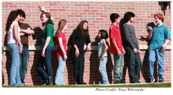  A group of adolescents talking outside of a building