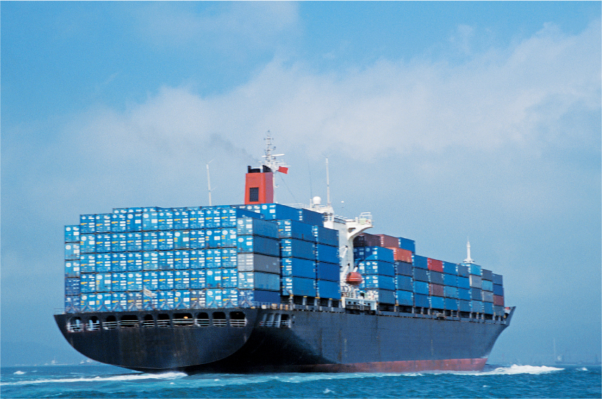A photo shows a ship fully loaded with containers in the middle of a sea