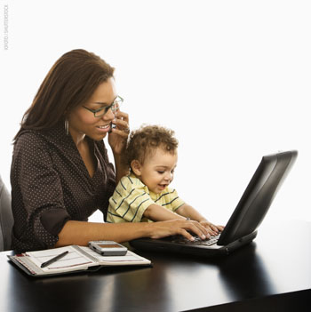 Picture of a mother on her laptop being interupted by her baby