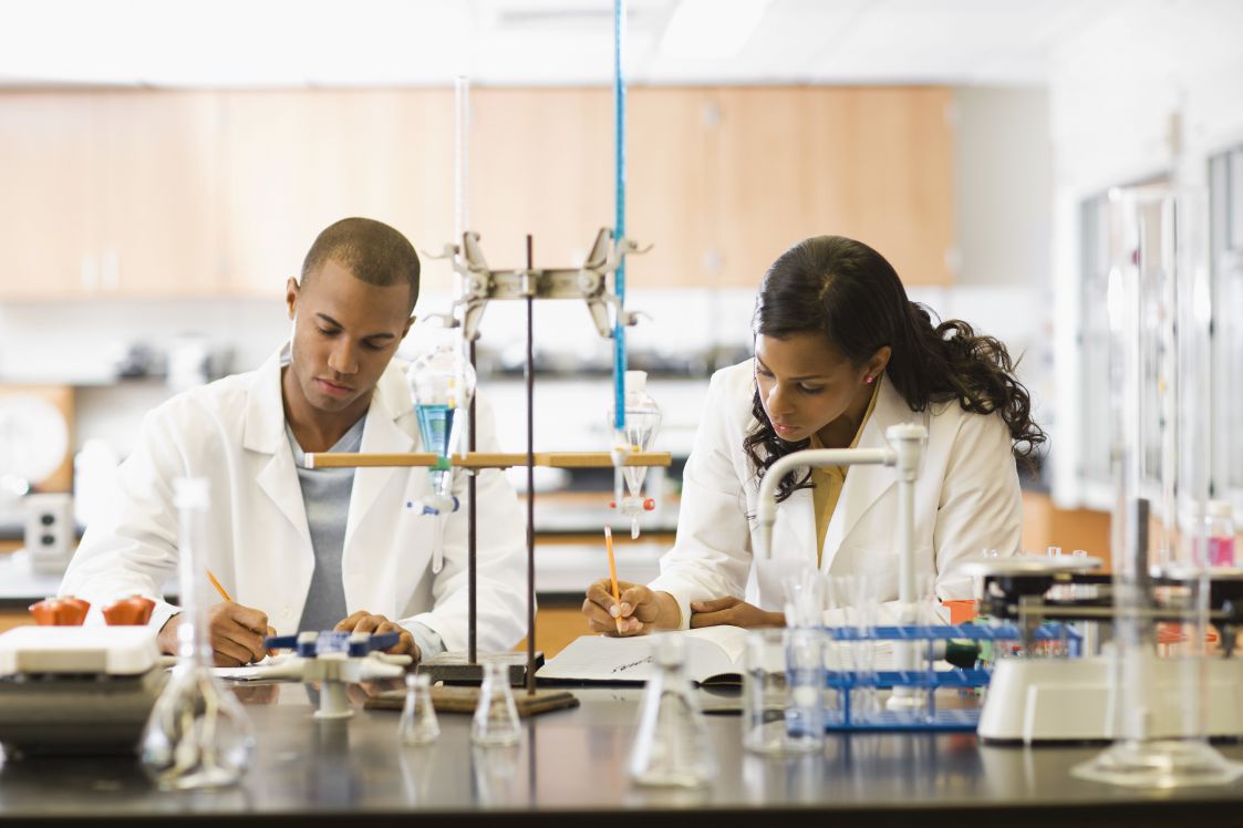 The photo shows a man and a woman working in a scientific laboratory.