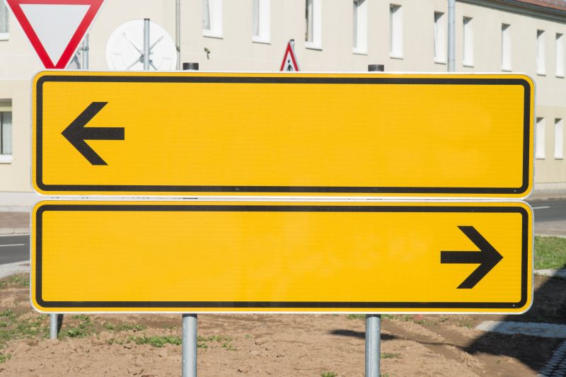This photo of a signboard points in opposite directions, which probably signifies a person who is multi-tasking.