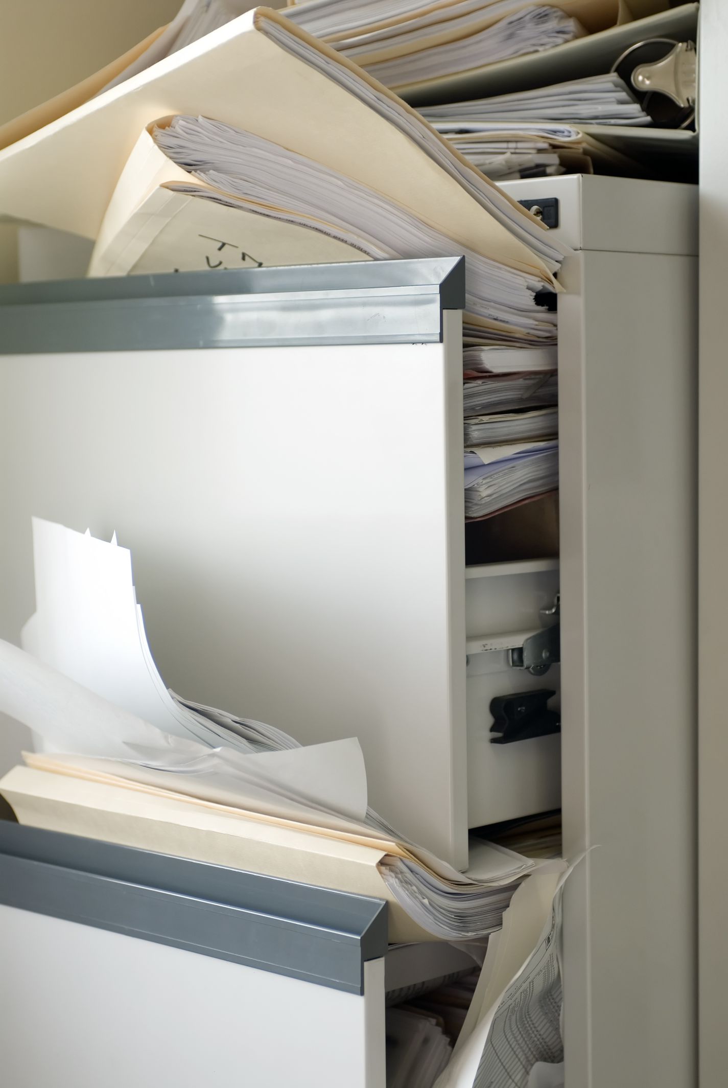 Photo shows a file drawer stuffed with many files indicating filed studies of ESP.