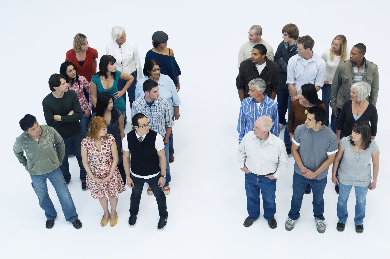 Two different groups of twelve people stand looking at each other perhaps to indicate that one group believes in the existence of ESP while the other group does not.