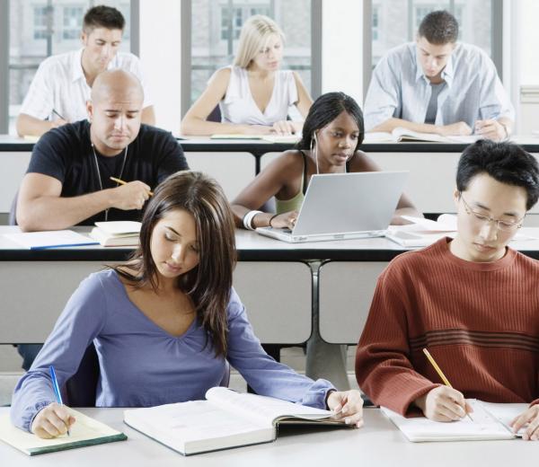 photo of a diverse classroom full of college-age students hard at work