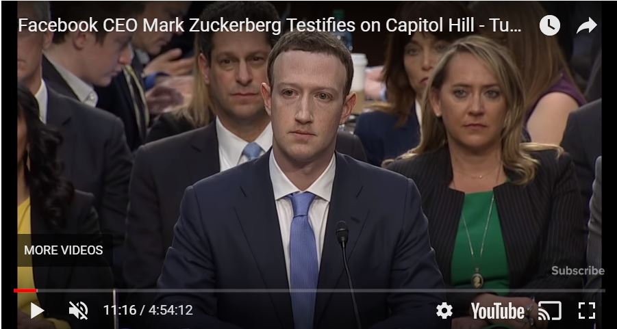 A screenshot from YouTube shows Mark Zuckerberg testifying on Capitol Hill in front of a crowd.