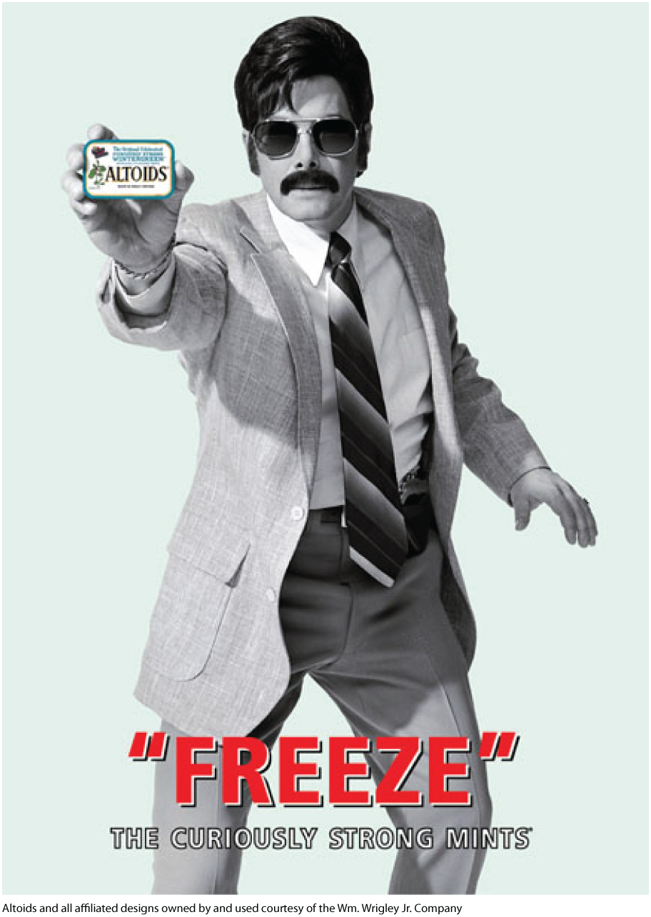 A poster shows a man with a moustache wearing a suit and holding a small altoids mint box. The poster reads Freeze. Altoids, the curiously strong mints.