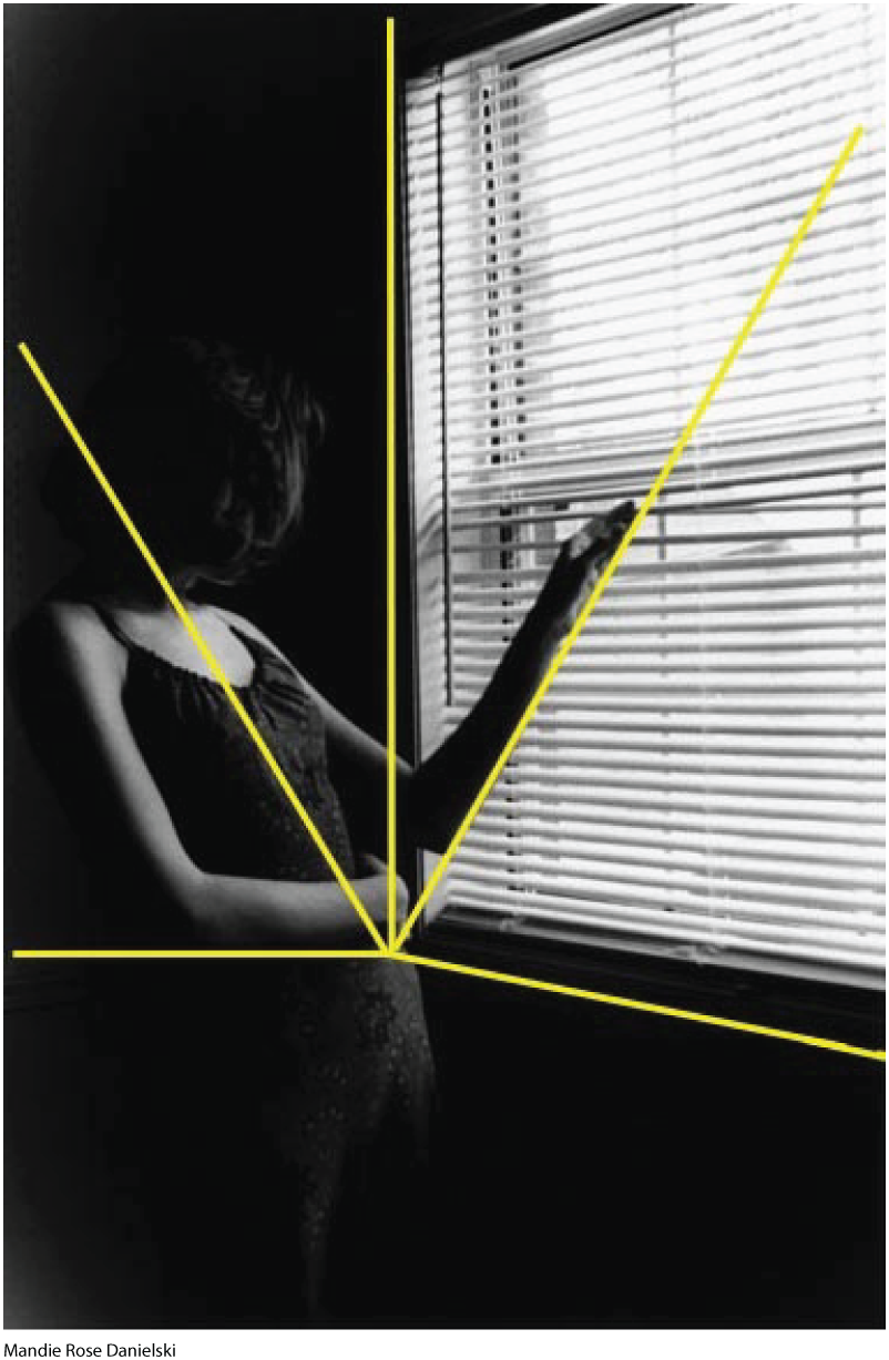 A photo shows a pregnant woman looking outside a window. Four yellow lines from various angles intersect at the woman's stomach.