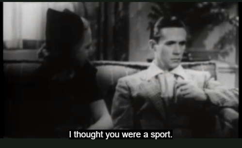 The woman is looking at the man who has turned his face away. The subtitle reads I thought you were a sport.