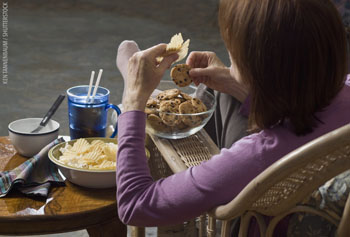 Picture of a woman eating cookies and chips